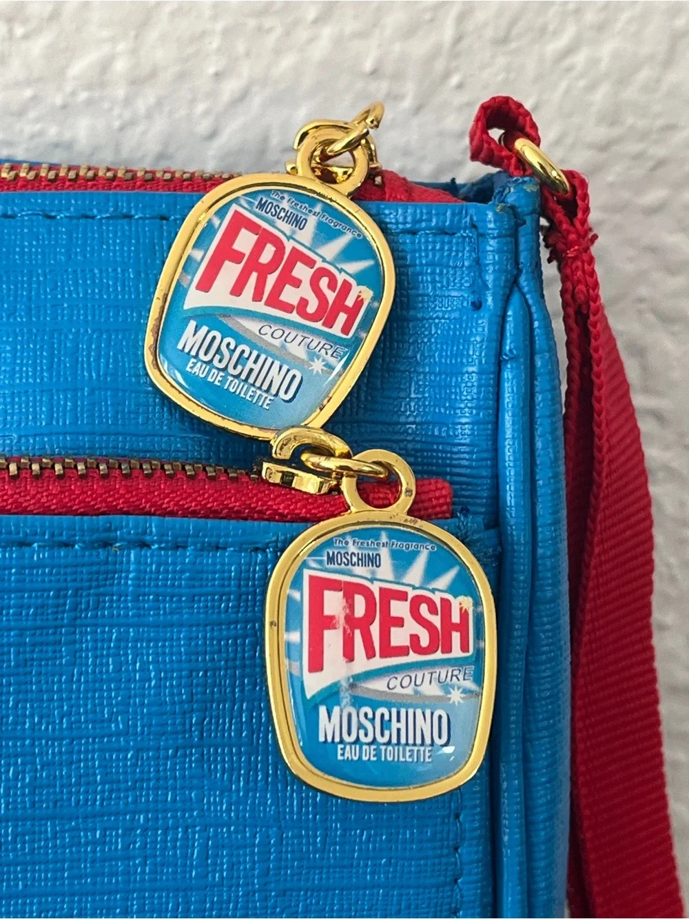 Moschino Bright Blue Cosmetic Pouch with Red Trim and 'Fresh' Charms